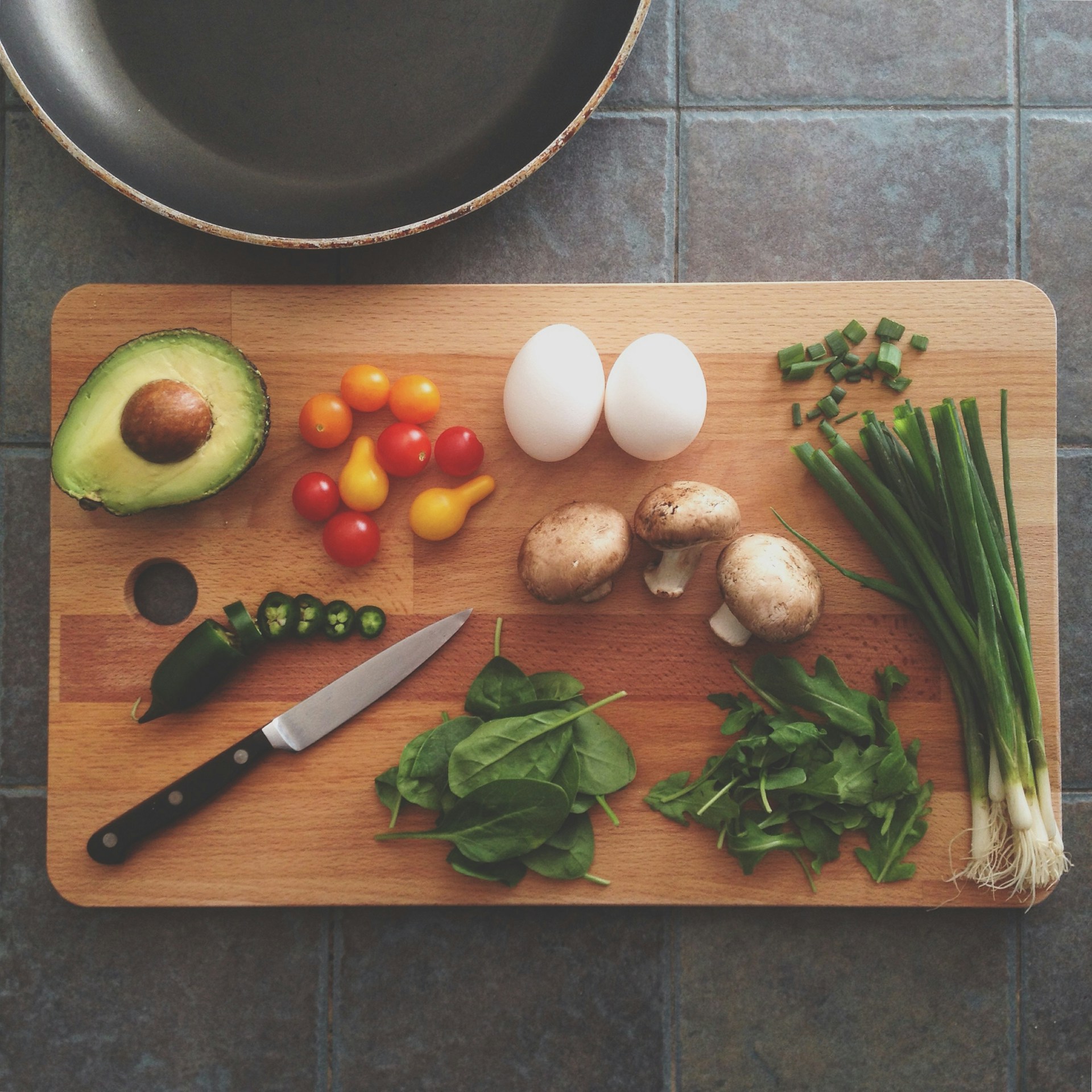 kitchen knife and vegetables on a cutting board